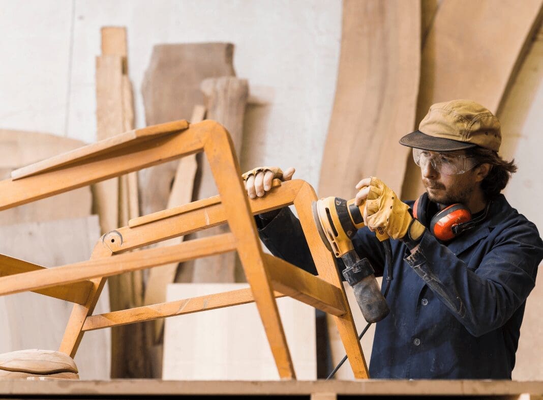 carpenter doing wood restoration on wooden chair