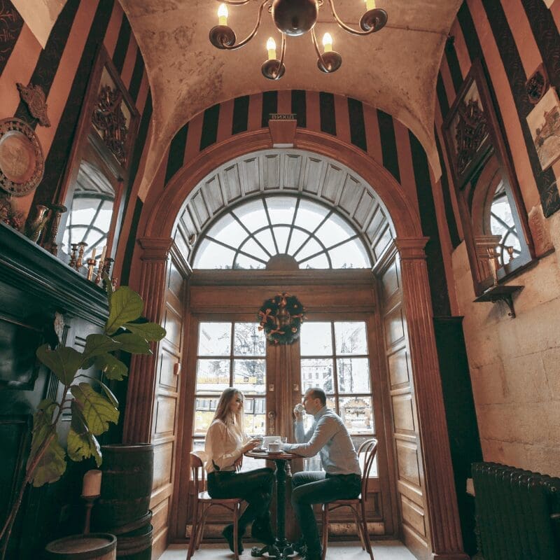 couple having tea in a well maintained historic building